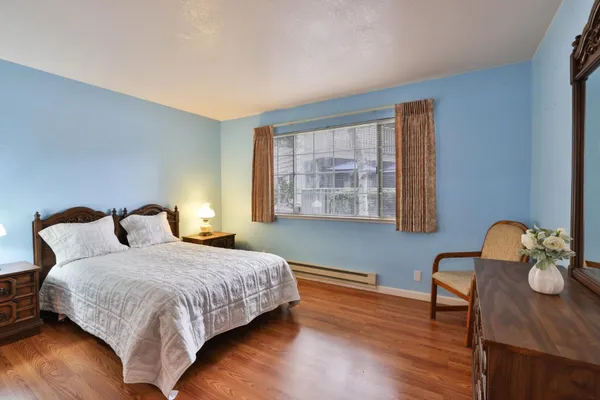 a bedroom with bed and a window