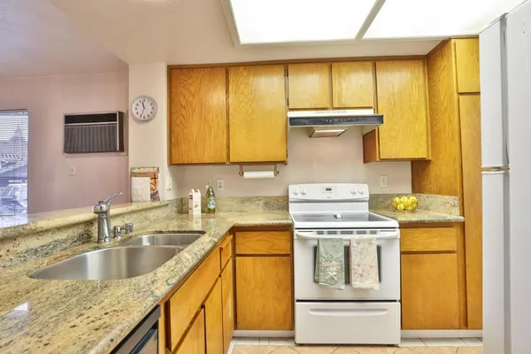 a kitchen with a stove a sink and a refrigerator