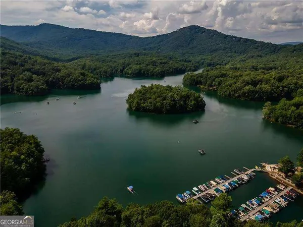 an aerial view of a house with a lake view