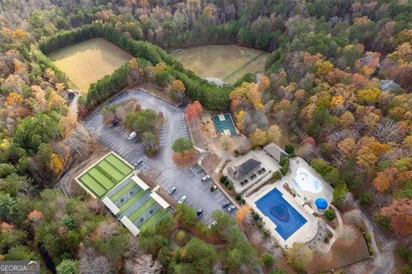 an aerial view of a house a yard and lake view