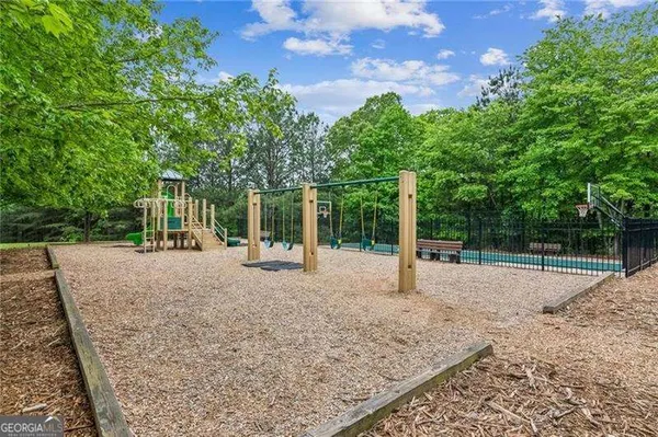 a view of a backyard with wooden fence