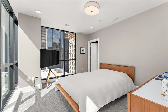 a bedroom with a bed and a tv