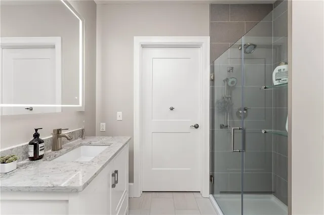 a bathroom with a shower and a sink