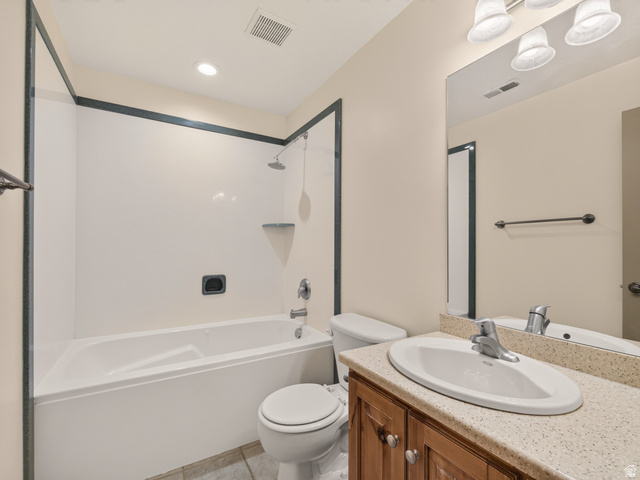 1279 West 1500th Street North Mapleton, UT 84664 - Photo 38 of 83 Full bathroom featuring a shower-over-tub combination with white surround, a wood-finish vanity with an oval basin, a speckled countertop, and a large wall-mounted mirror