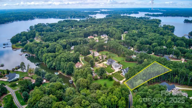 an aerial view of a house with a garden and lake view