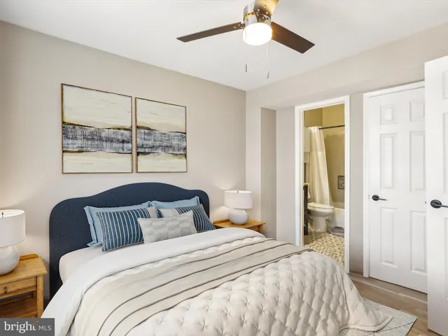 a bedroom with a bed and a painting on the wall