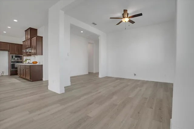 a kitchen with stainless steel appliances granite countertop a sink a stove and a wooden floors