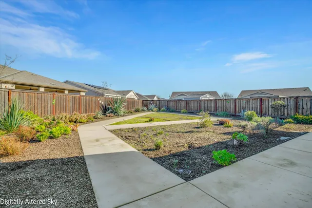 an aerial view of a house with a garden and plants