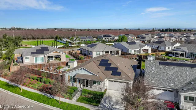 a view of a house with backyard and sitting area