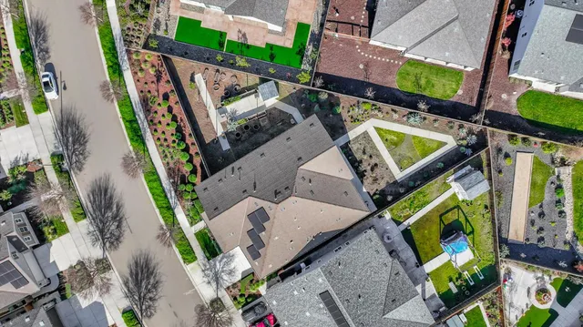 a front view of a house with a garden and plants