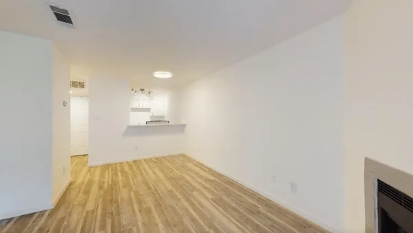 a view of a room with wooden floor and a window