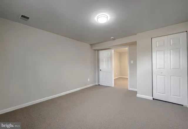 a view of an empty room and closet area