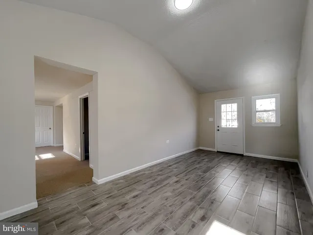a view of a room with wooden floor and window