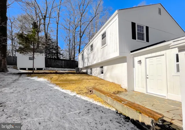a view of an house with backyard and trees
