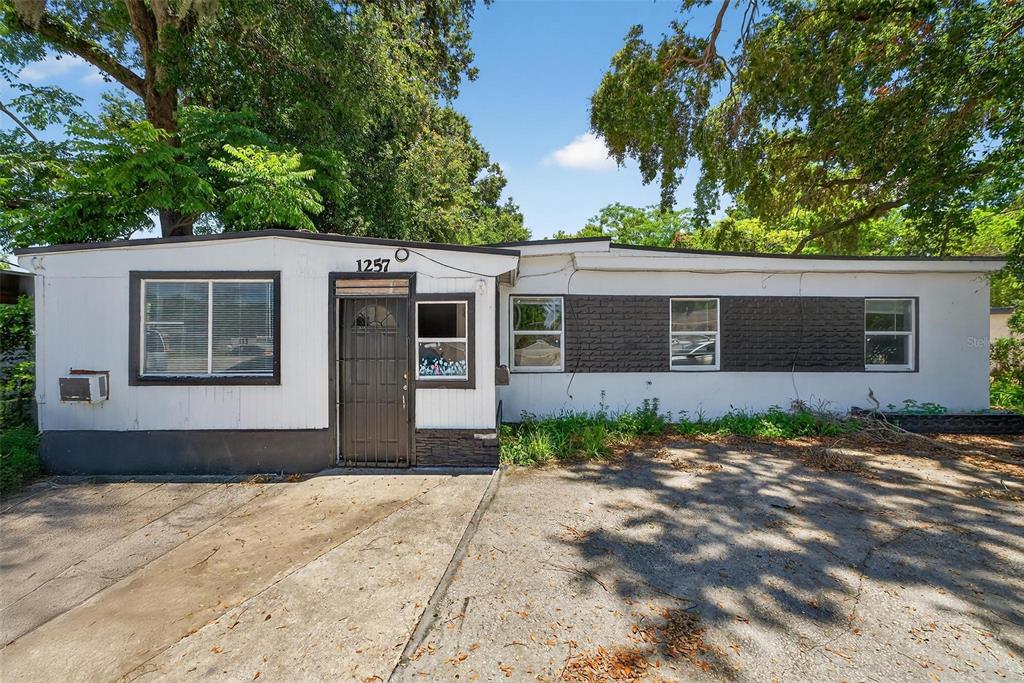 1257 North Pine Hills Road Orlando, FL 32808 - Photo 1 of 35 a front view of a house with garden