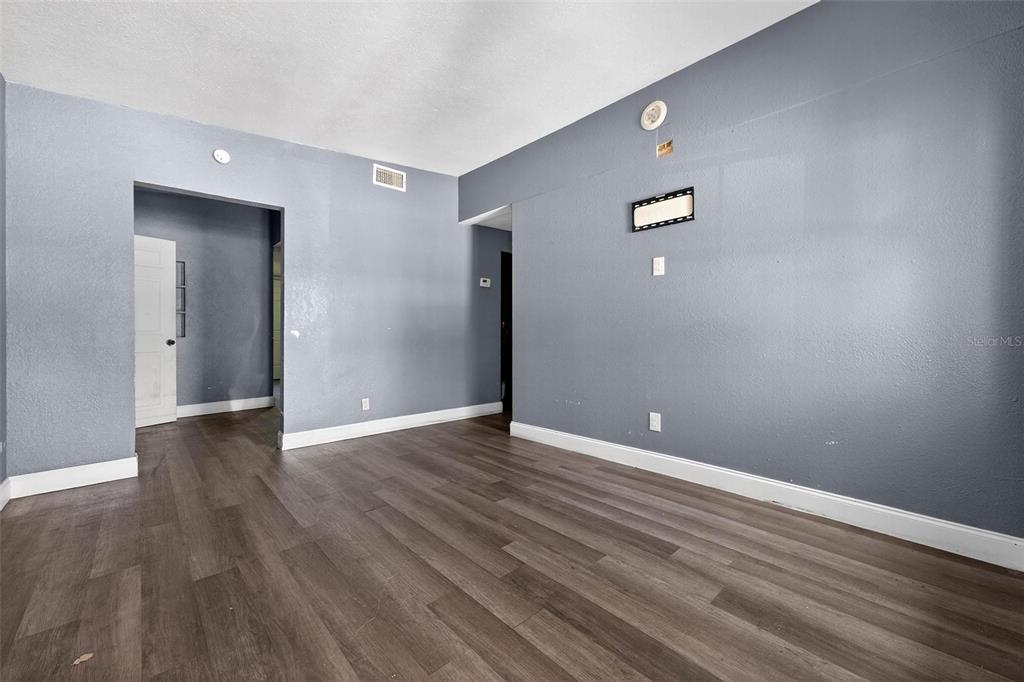 1257 North Pine Hills Road Orlando, FL 32808 - Photo 2 of 35 a view of an empty room with wooden floor and closet