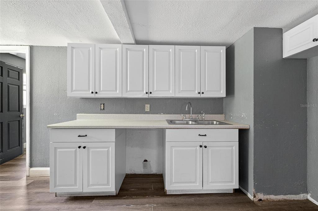 1257 North Pine Hills Road Orlando, FL 32808 - Photo 21 of 35 a kitchen with cabinets appliances and a counter space