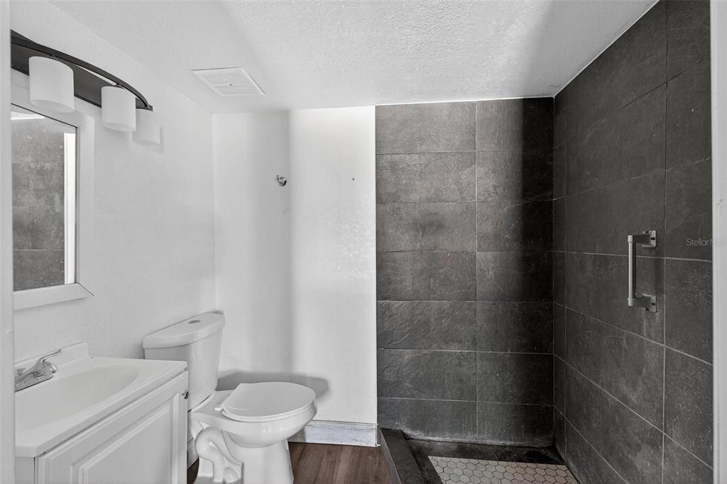 1257 North Pine Hills Road Orlando, FL 32808 - Photo 24 of 35 a bathroom with a shower toilet and sink