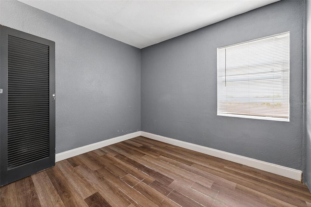 1257 North Pine Hills Road Orlando, FL 32808 - Photo 26 of 35 a view of a room with wooden floor and windows