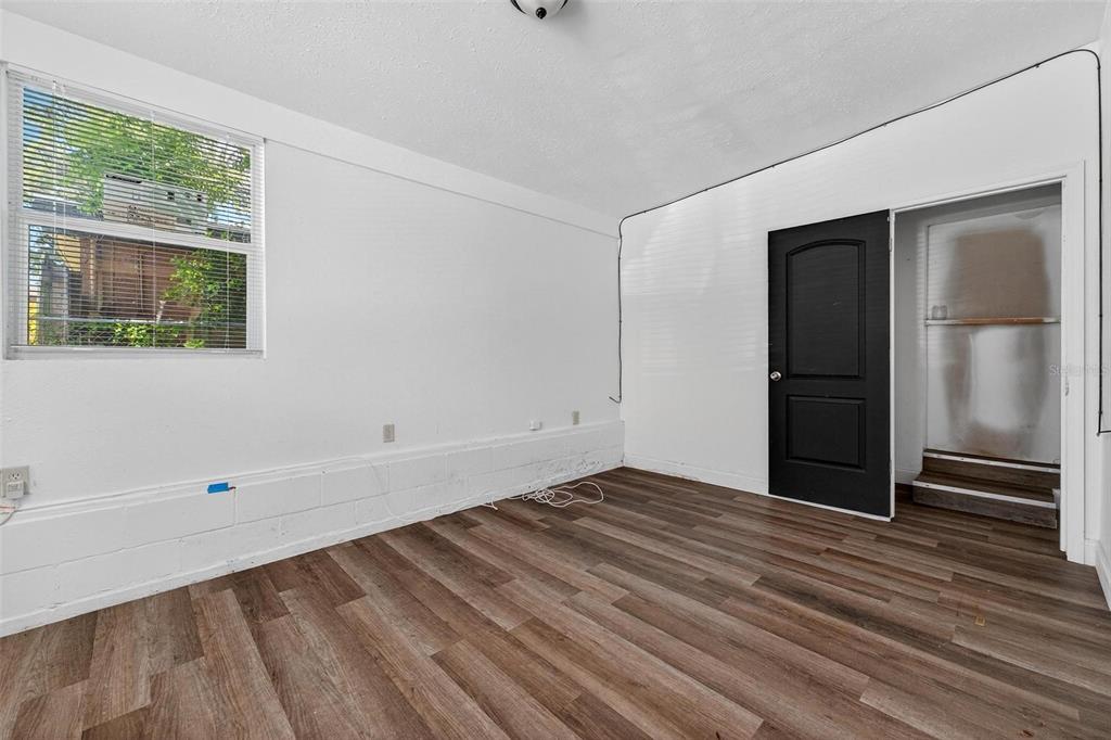 1257 North Pine Hills Road Orlando, FL 32808 - Photo 29 of 35 a view of an empty room with wooden floor and a window