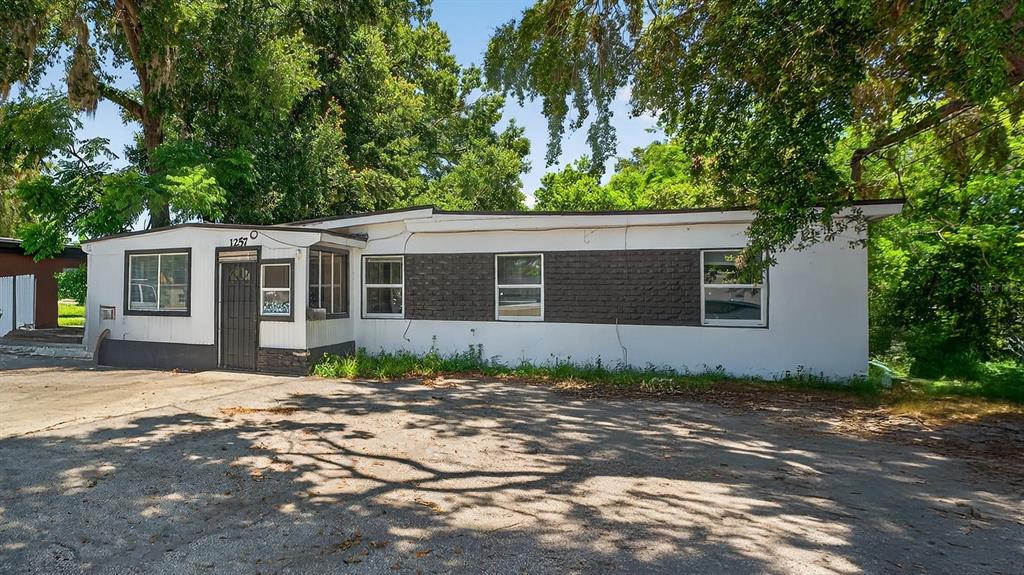 1257 North Pine Hills Road Orlando, FL 32808 - Photo 35 of 35 a front view of a house with a garden