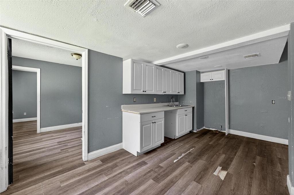 1257 North Pine Hills Road Orlando, FL 32808 - Photo 7 of 35 a view of kitchen with wooden floor and electronic appliances