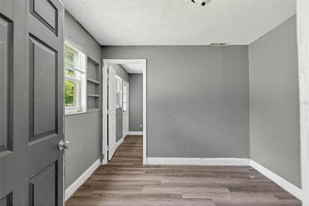 1257 North Pine Hills Road Orlando, FL 32808 - Photo 9 of 35 a view of a hallway with wooden floor and staircase