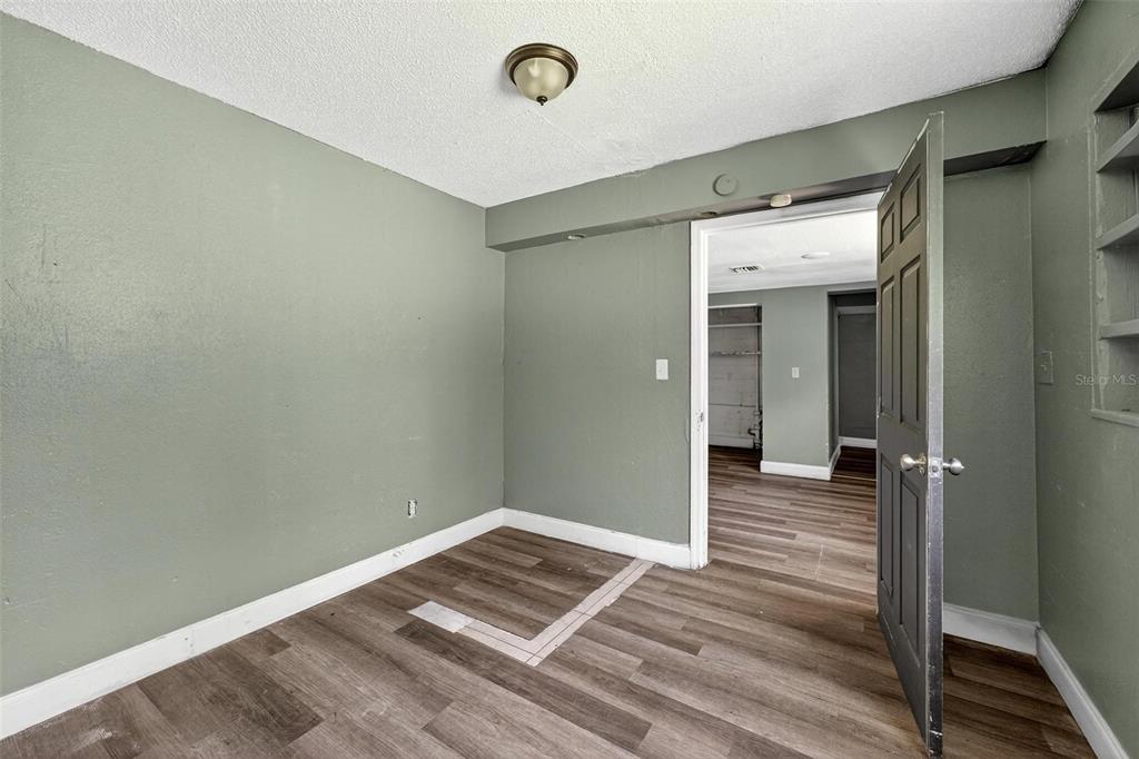 1257 North Pine Hills Road Orlando, FL 32808 - Photo 10 of 35 a view of a room with wooden floor and bathroom