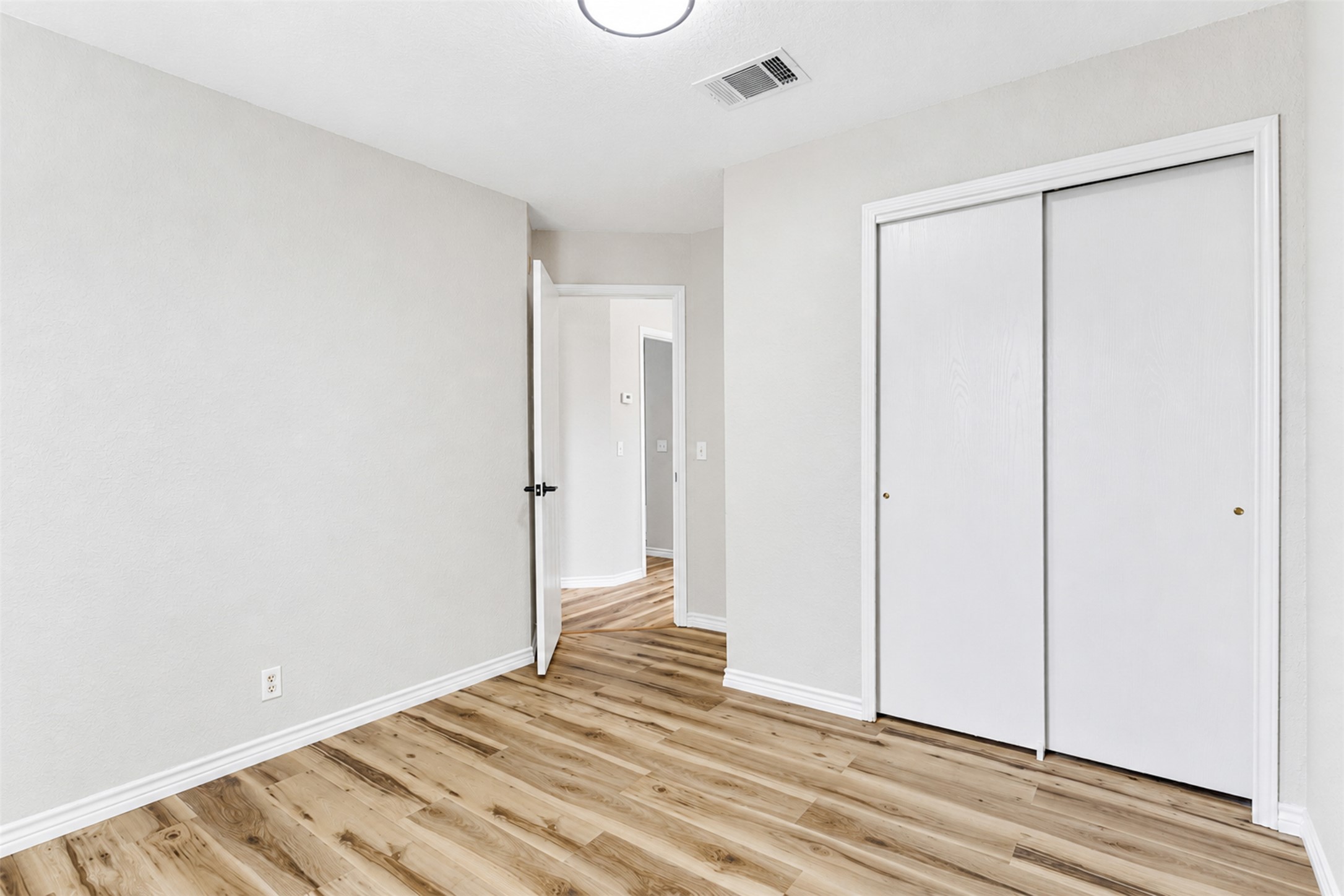 4523 Secure Lane Austin, TX 78725 - Photo 30 of 40 Laminate wood flooring and a spacious closet create a practical and appealing living space.