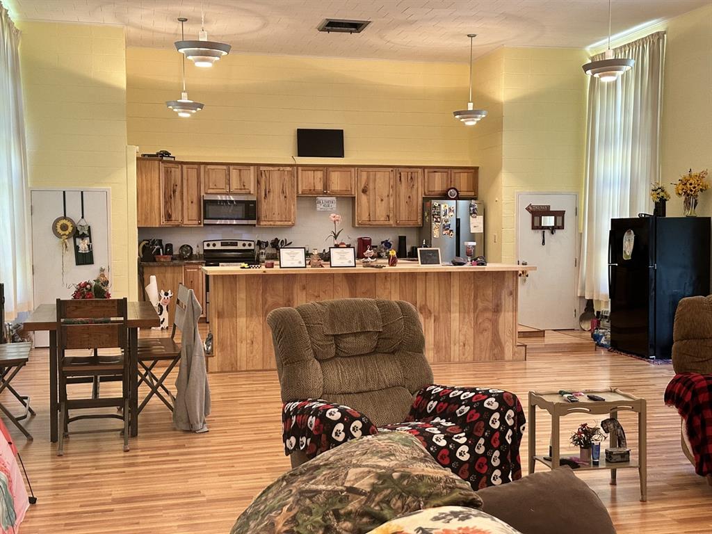 4914 Highway 507 Coushatta, LA 71019 - Photo 5 of 25 a kitchen with stainless steel appliances kitchen island granite countertop a refrigerator and a stove top oven