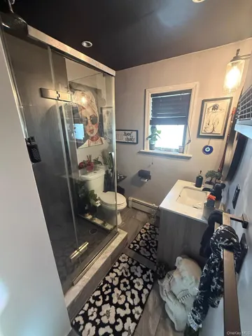 a bathroom with a toilet a sink and a mirror