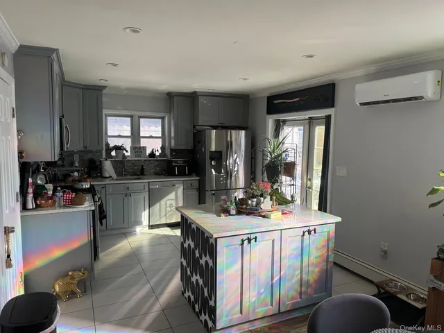 a kitchen with stainless steel appliances granite countertop a stove a sink dishwasher and cabinets with wooden floor