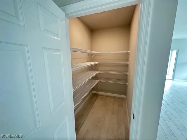 a view of walk in closet with empty racks