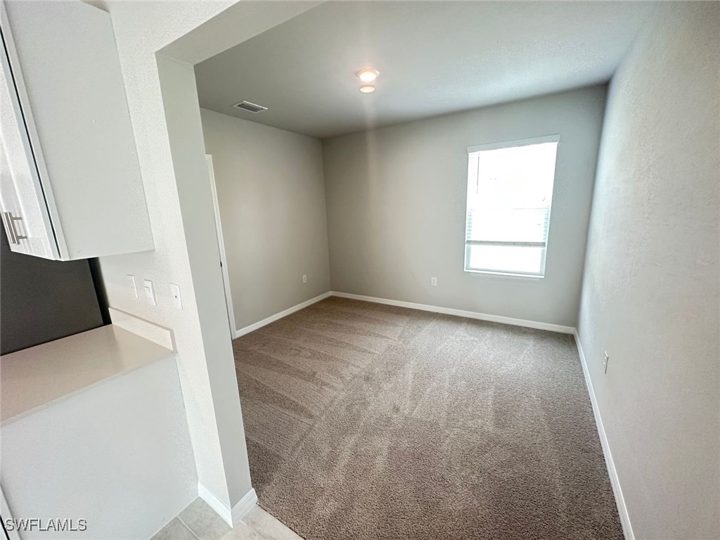 801 Serenity Lane LaBelle, FL 33935 - Photo 8 of 12 a view of empty room with wooden floor and fan