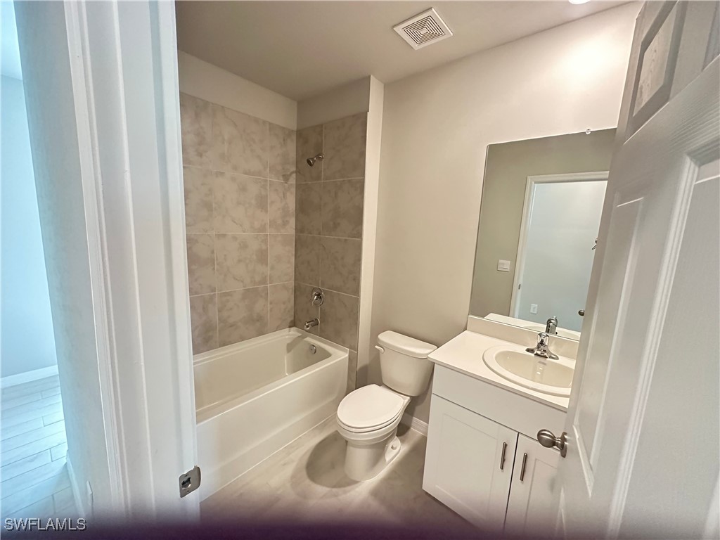 801 Serenity Lane LaBelle, FL 33935 - Photo 10 of 12 a bathroom with a bathtub shower sink mirror and toilet