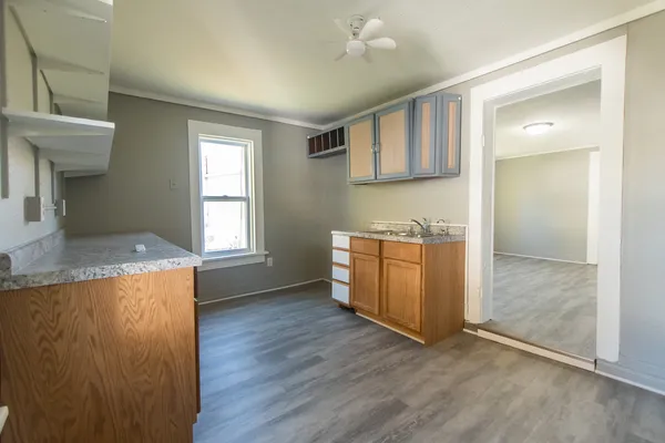 wooden floor in an empty room with a window and wooden floor