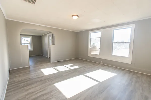 wooden floor in an empty room with a window