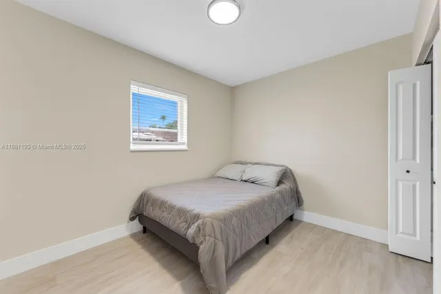 a bedroom with a bed and a mirror