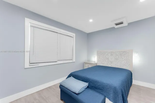 a kitchen with cabinets and wooden floor
