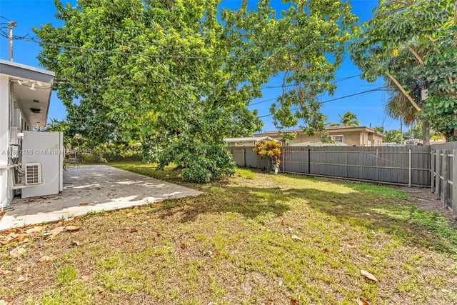 an aerial view of residential houses with green space