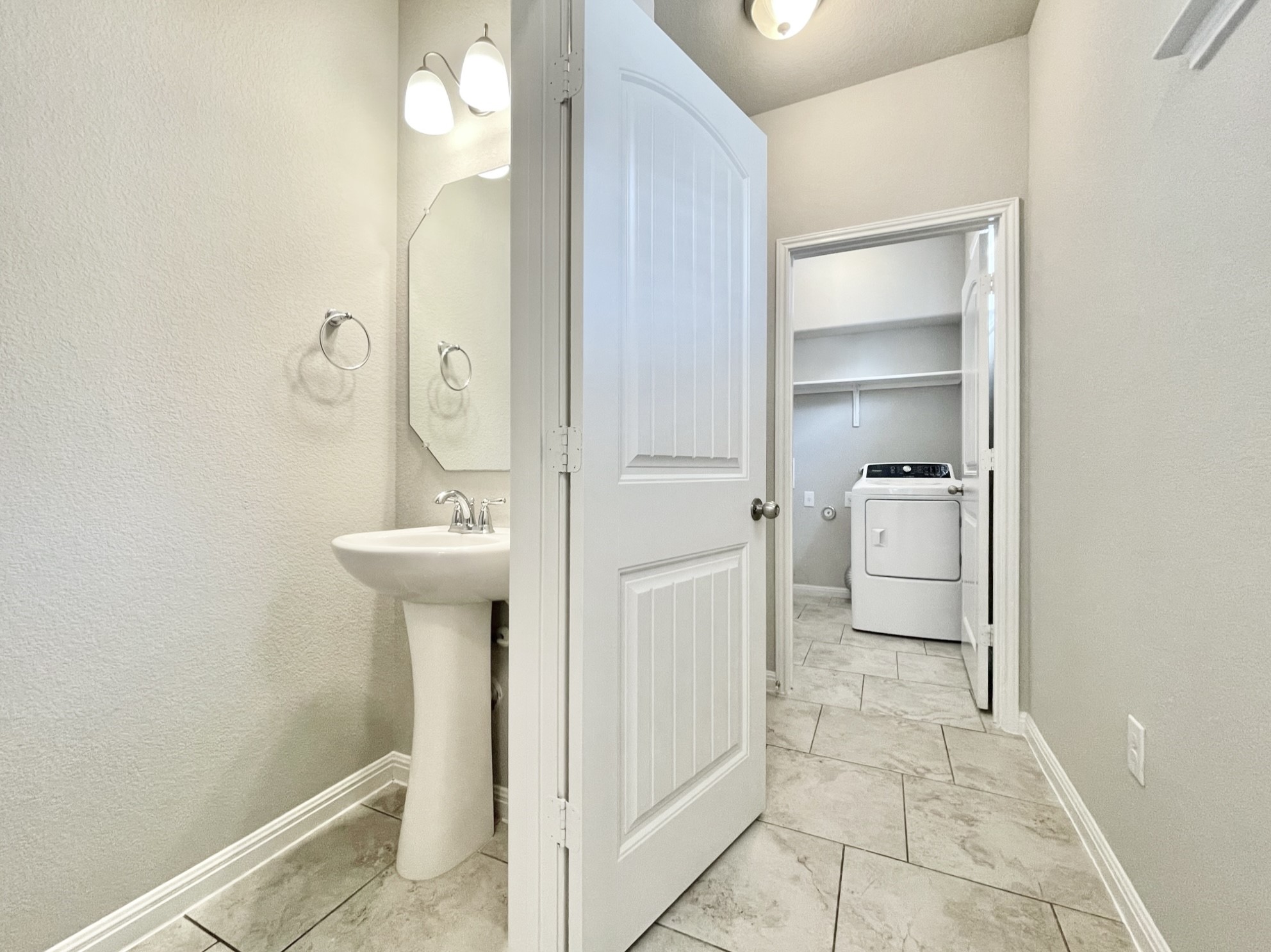 407 Rhetoric Way Pflugerville, TX 78660 - Photo 15 of 38 a bathroom with a sink a mirror and a shower