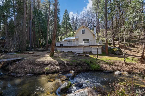 a view of backyard of house with green space