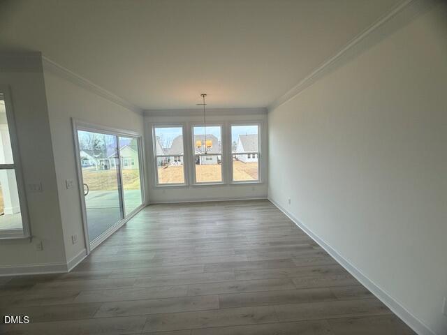 25 Slippery Elm Road Youngsville, NC 27596 - Photo 11 of 36 an empty room with wooden floor and windows