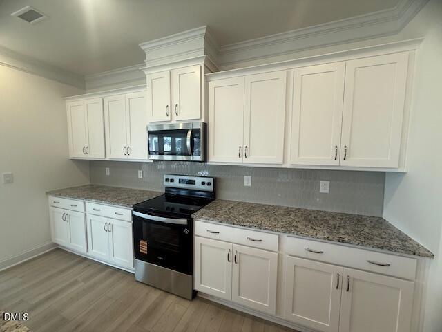 25 Slippery Elm Road Youngsville, NC 27596 - Photo 13 of 36 a kitchen with granite countertop white cabinets and a stove