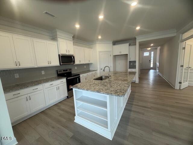 25 Slippery Elm Road Youngsville, NC 27596 - Photo 14 of 36 a kitchen with granite countertop a stove top oven a sink dishwasher and a refrigerator