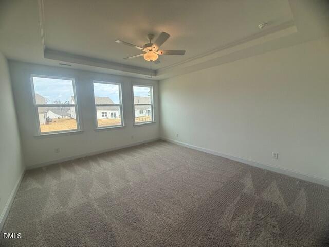 25 Slippery Elm Road Youngsville, NC 27596 - Photo 15 of 36 an empty room with a chandelier fan and windows
