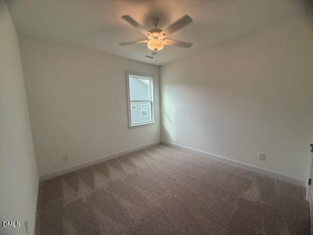 25 Slippery Elm Road Youngsville, NC 27596 - Photo 7 of 36 an empty room with windows and chandelier fan