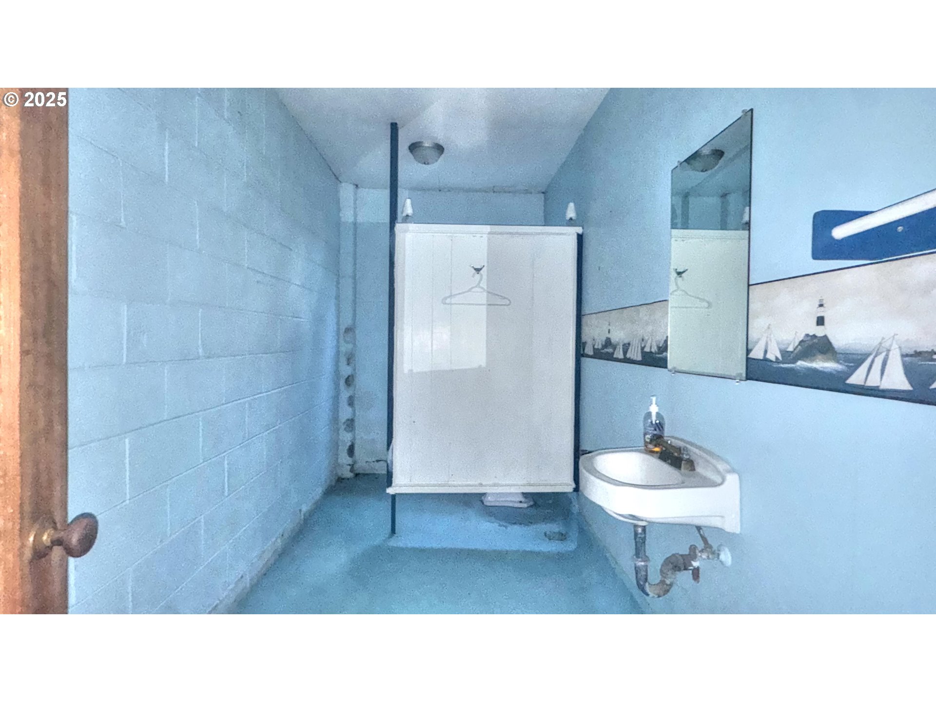 33043 Nesika Road Gold Beach, OR 97444 - Photo 13 of 23 a bathroom with a sink toilet a mirror and vanity