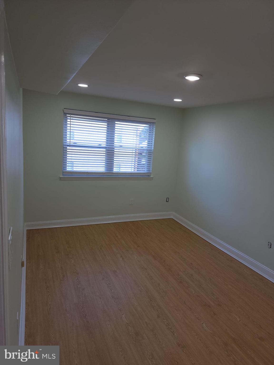 8303 Ridgeway Street Philadelphia, PA 19111 - Photo 11 of 24 an empty room with wooden floor and windows