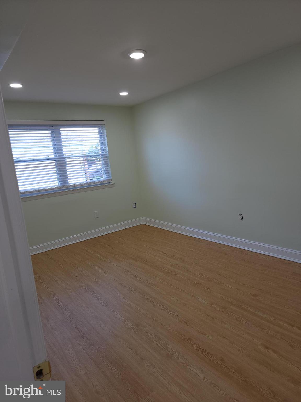 8303 Ridgeway Street Philadelphia, PA 19111 - Photo 14 of 24 an empty room with wooden floor and windows
